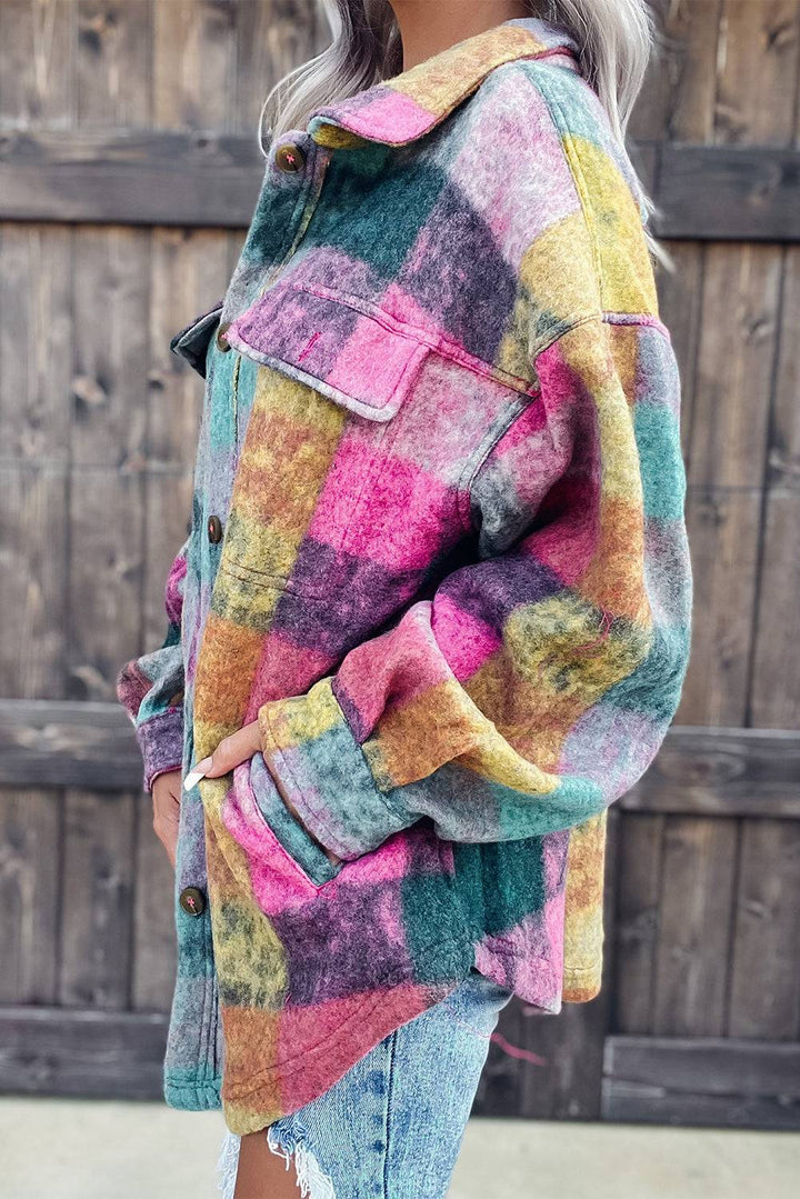 a woman wearing a multi colored jacket