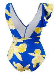 a woman in a blue and yellow floral print swimsuit