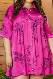a woman wearing a pink dress with a leopard print on it