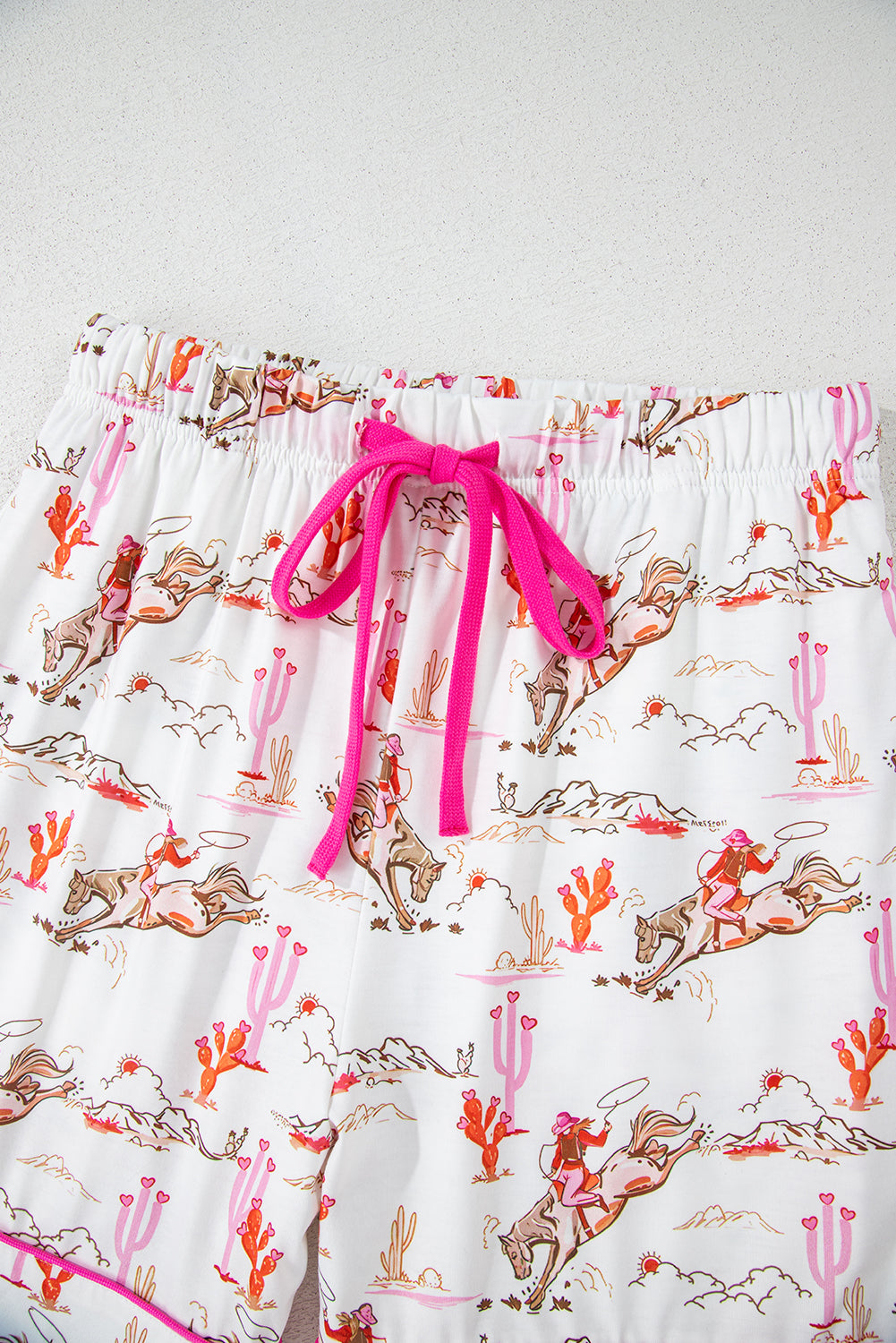 Close-up of button and collar detail on White Cowgirl Country Print Pajamas Set with pink piping. Shop White Cowgirl Country Print Pajamas Set at Faith & Co. Boutique.