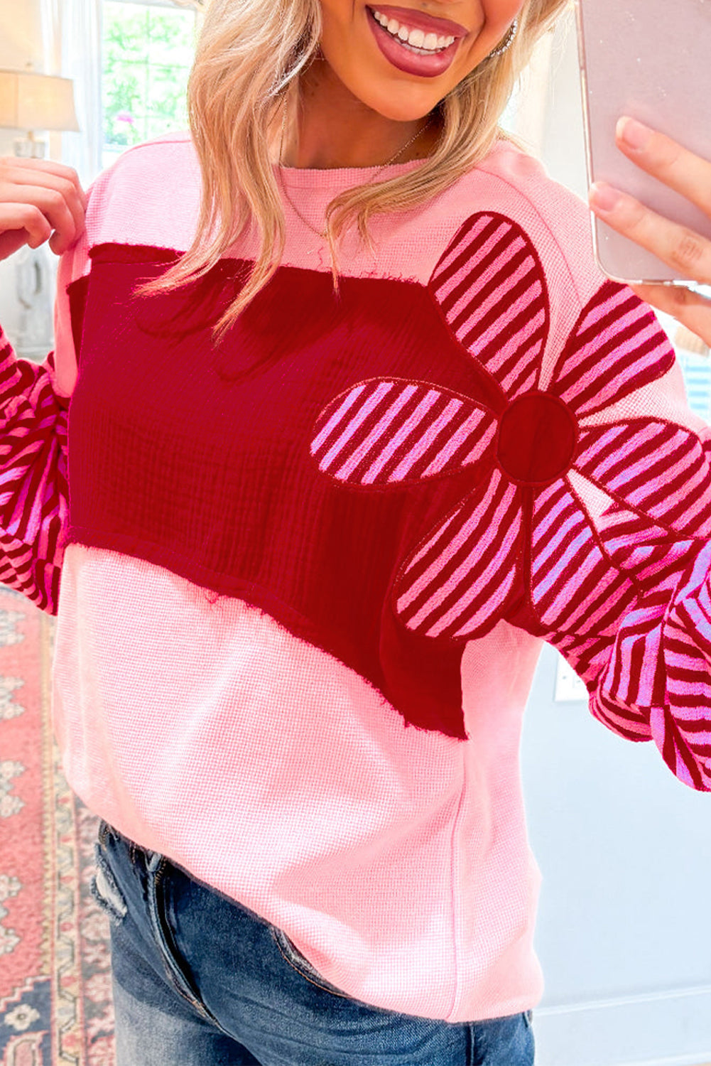 Close-up of Pink Floral Patch Color Block Striped Sleeve Textured Top showing waffle knit fabric and striped floral applique detail.