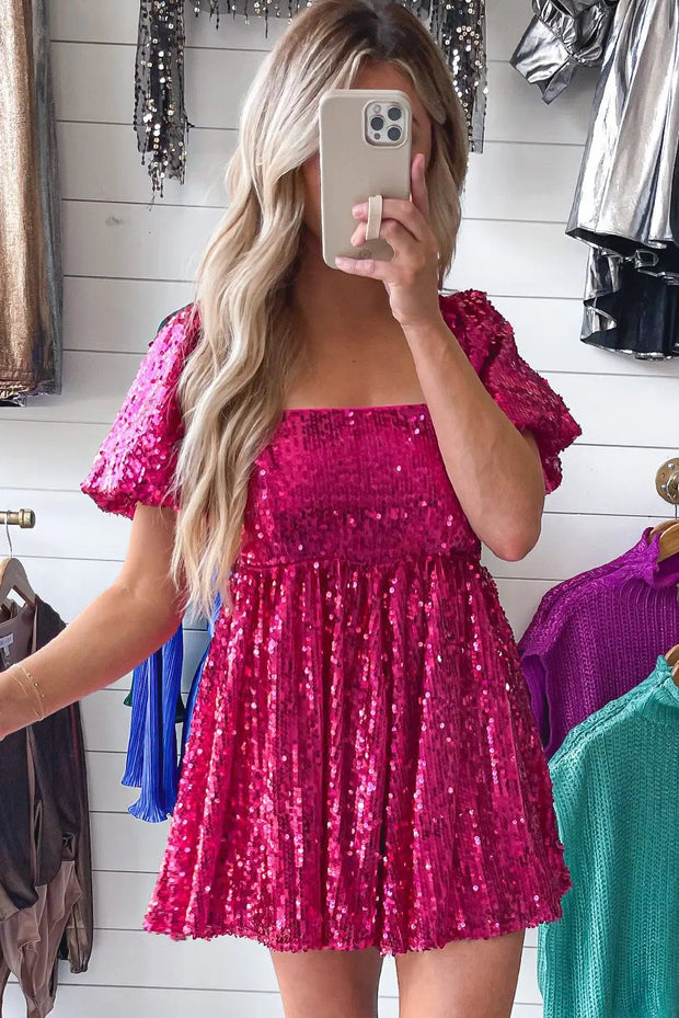 a woman taking a selfie in a pink dress