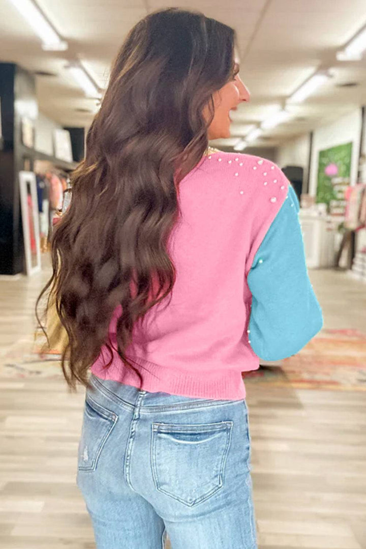 a woman with long hair standing in a room