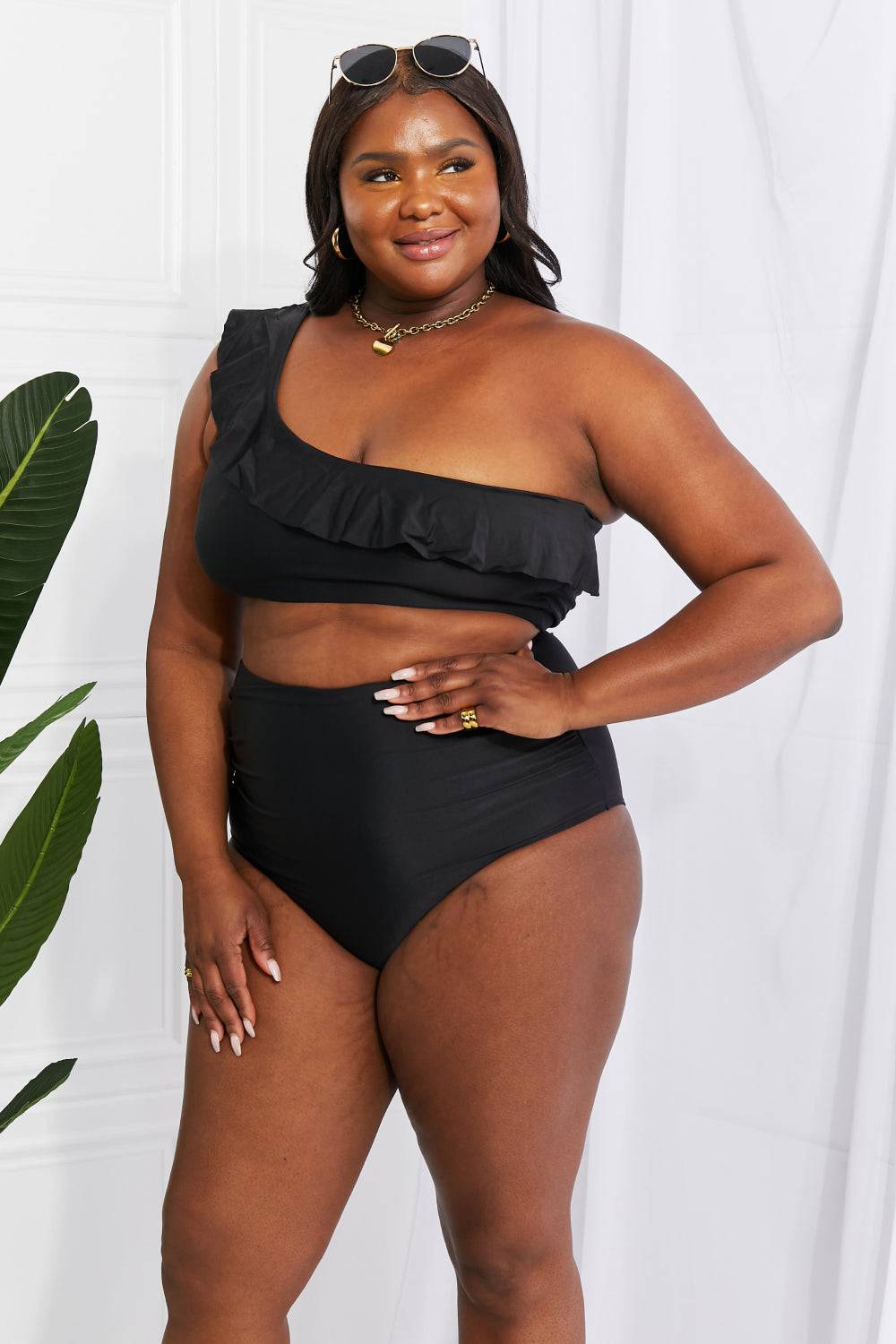 a woman in a black swimsuit posing for a picture
