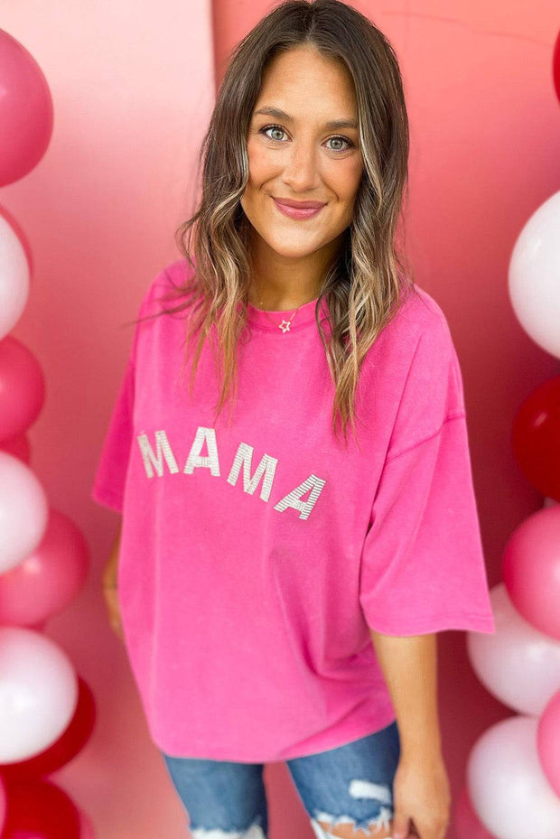 a woman standing in front of balloons wearing a pink shirt
