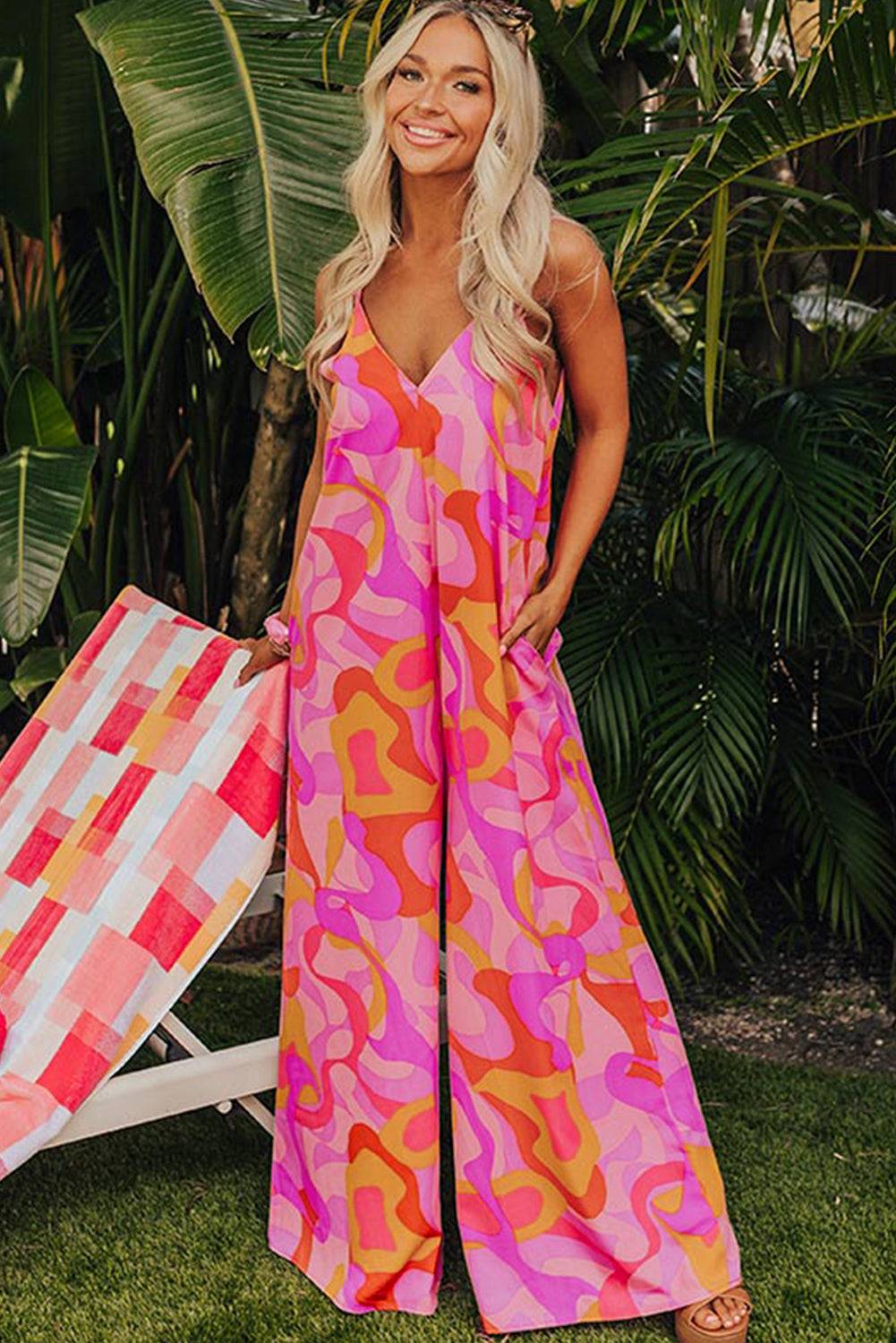 a woman in a pink and orange patterned jumpsuit