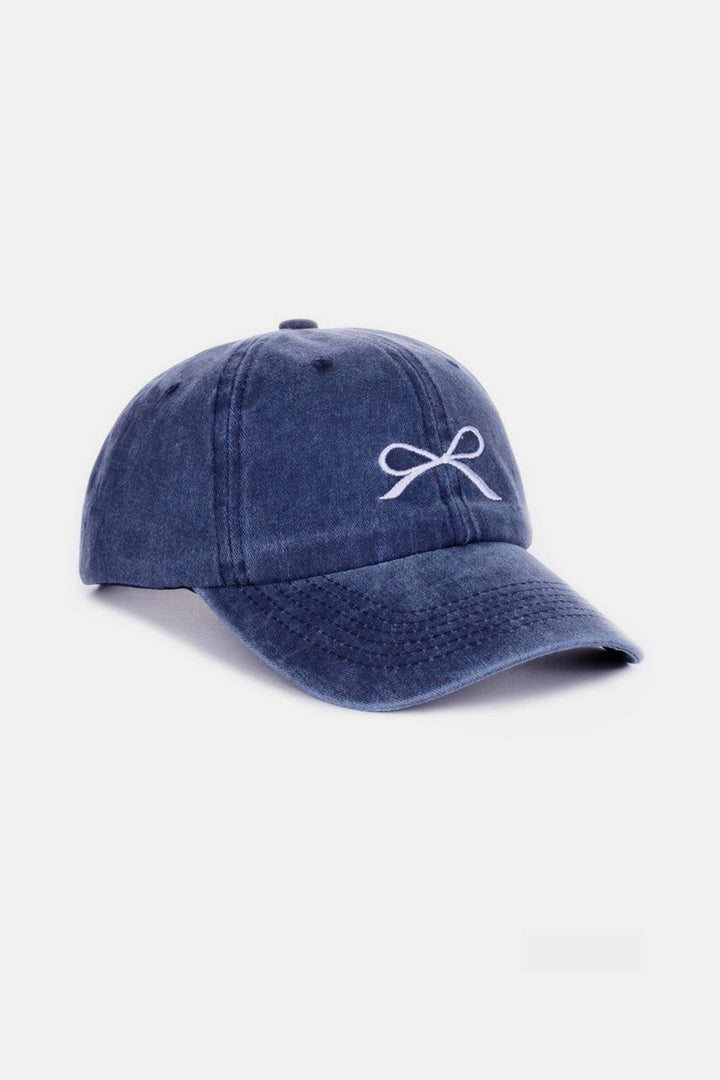 a blue hat with a white bow on it