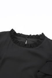 a black top with ruffles on the shoulders