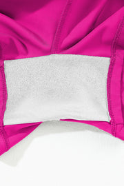 a close up of a pink jacket with a white pillow