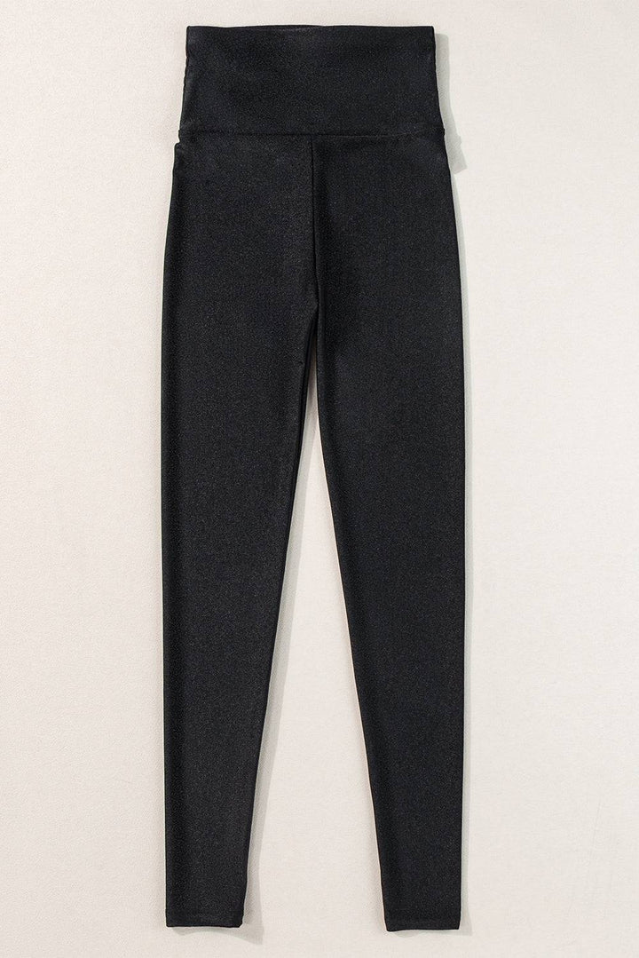 a pair of black pants hanging on a wall