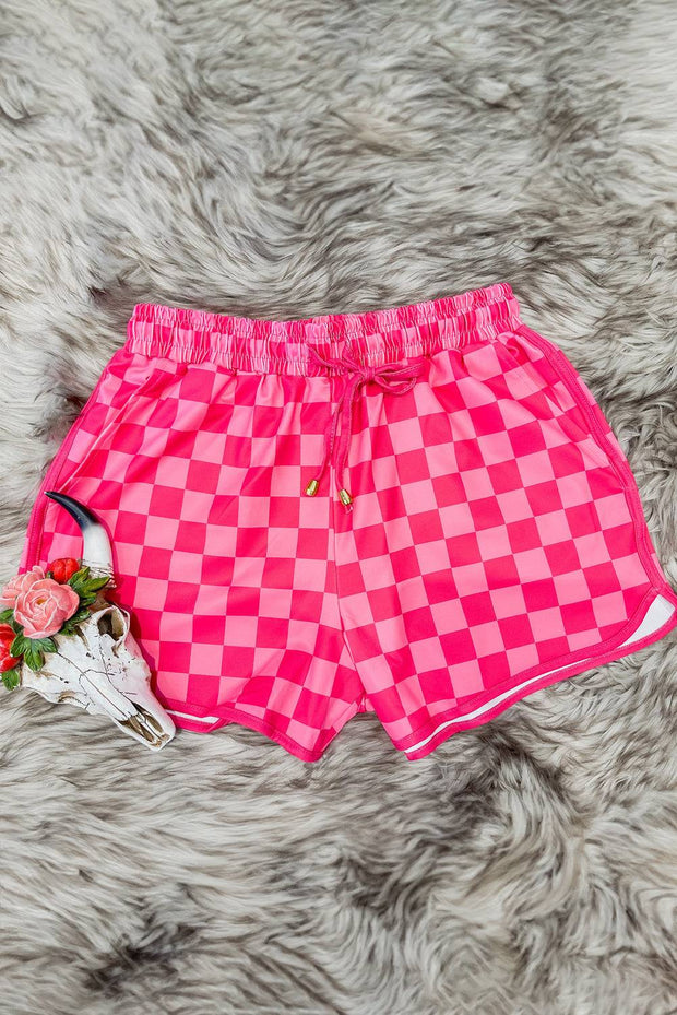 a pink and white checkered shorts with a flower on it