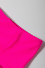 a close up of a pink skirt on a white surface