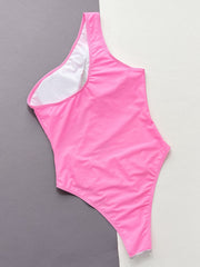 a pink one piece swimsuit on a gray and white background