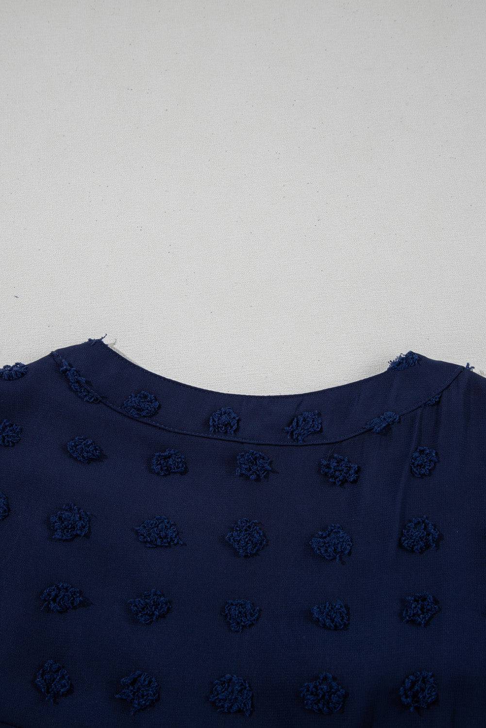 Neckline detail of Navy Blue Dotty Textured Notched Neck Plus Ruffled Dress, emphasizing soft collar and textured dot pattern.