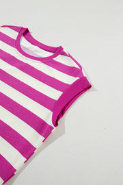 a pink and white striped shirt laying on a white surface
