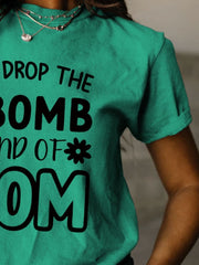 a woman wearing a t - shirt that says drop the bomb and of com