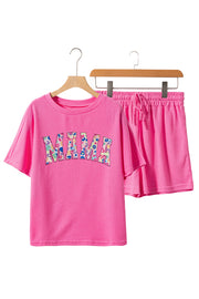 a pink shirt and shorts are hanging on a rack