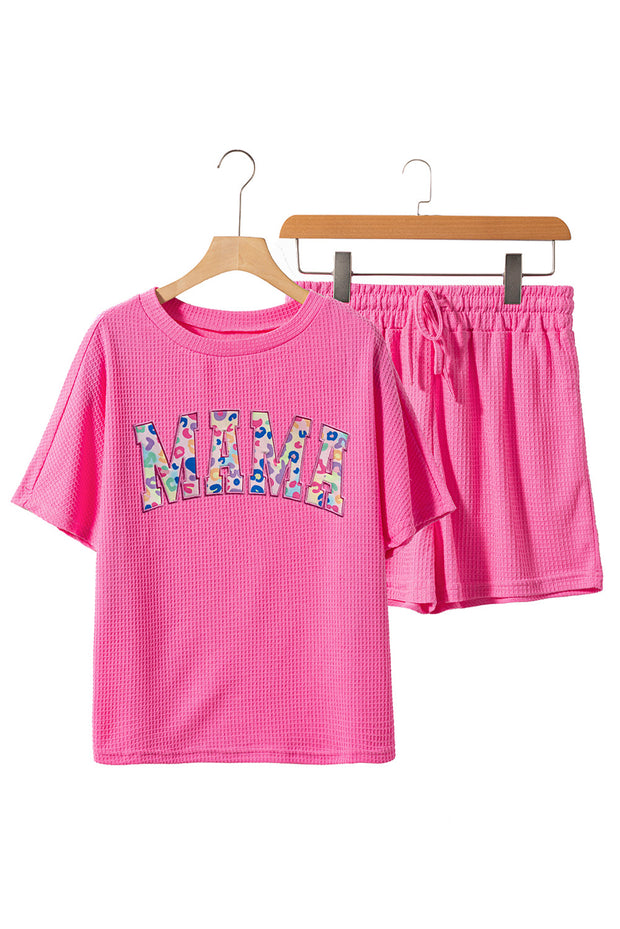a pink shirt and shorts are hanging on a rack