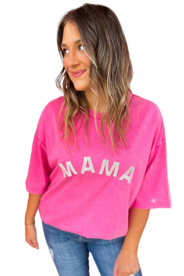 a woman wearing a pink shirt that says aman