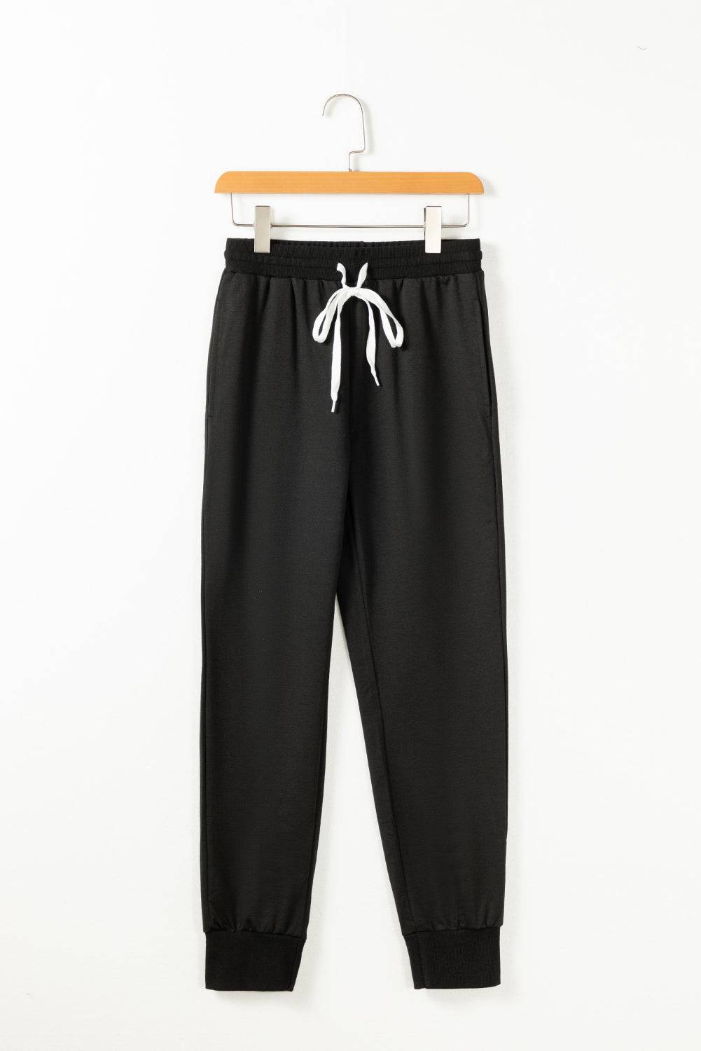 a black sweat pants hanging on a hanger