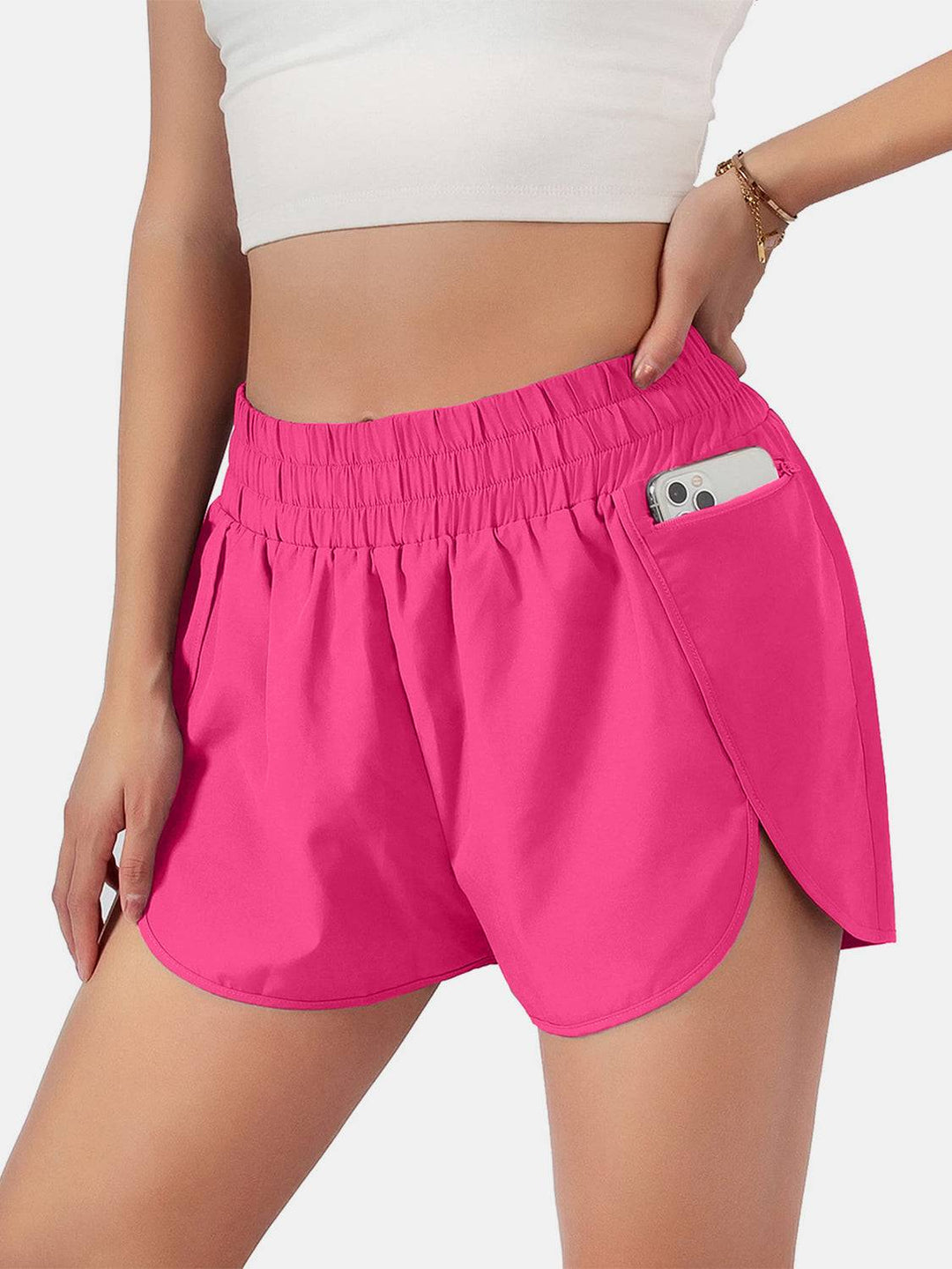 a woman in pink shorts with a cell phone in her pocket