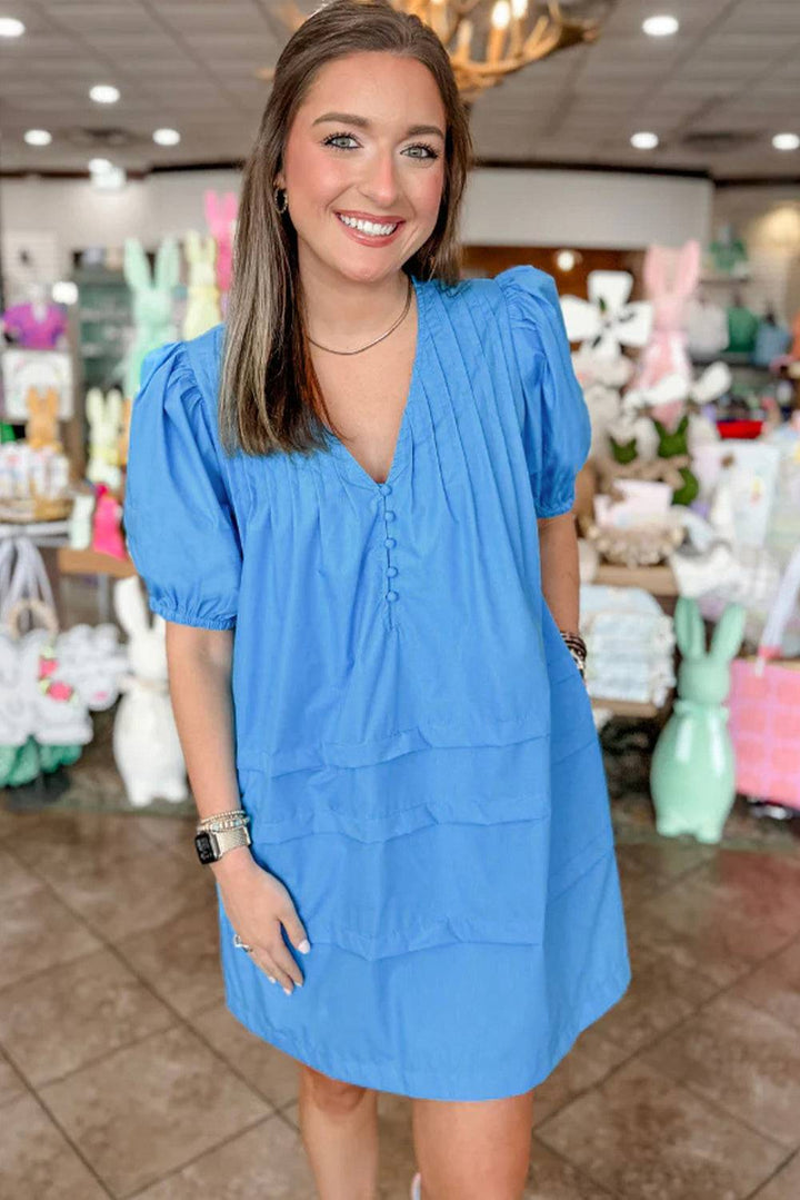 a woman in a blue dress standing in a store