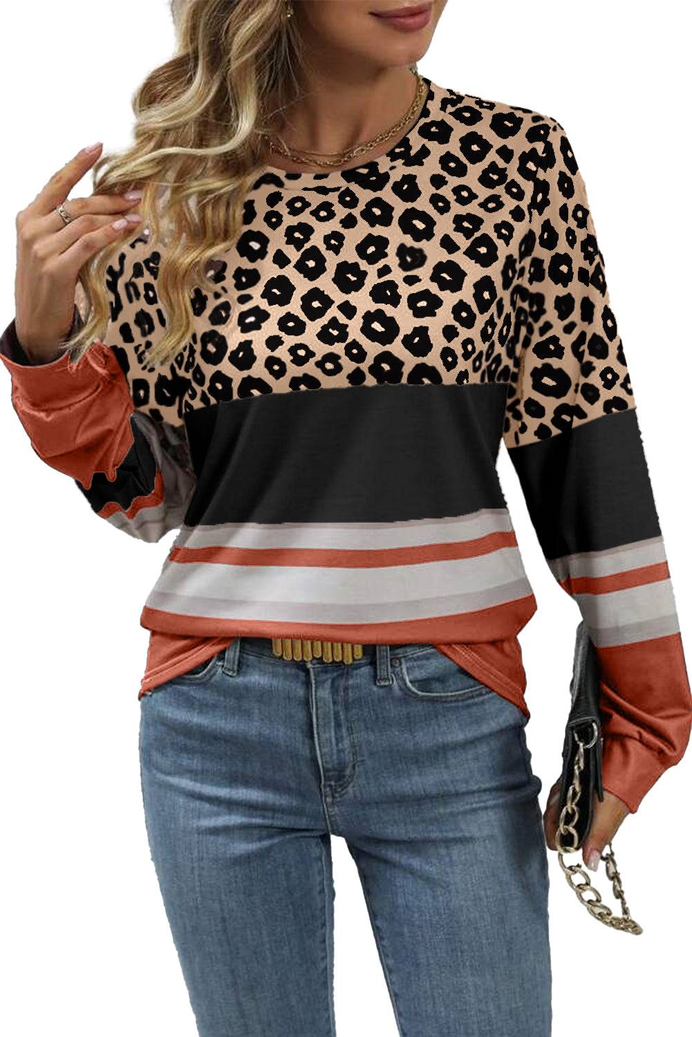 a woman wearing a leopard print top and jeans