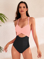a woman in a pink and black one piece swimsuit
