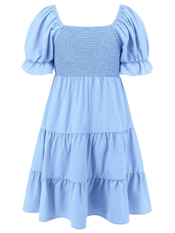 a blue dress with ruffles on the shoulders