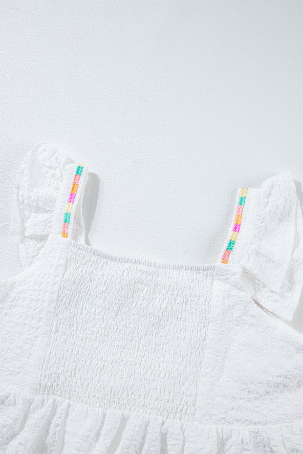 a white dress with a colorful stripe on it