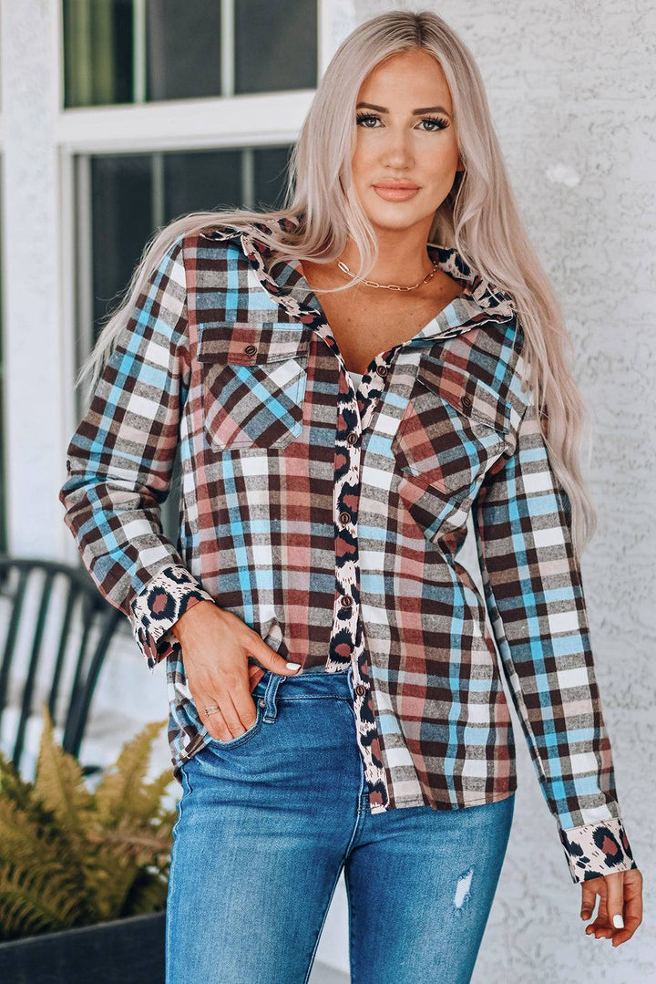 a woman wearing a plaid shirt and jeans