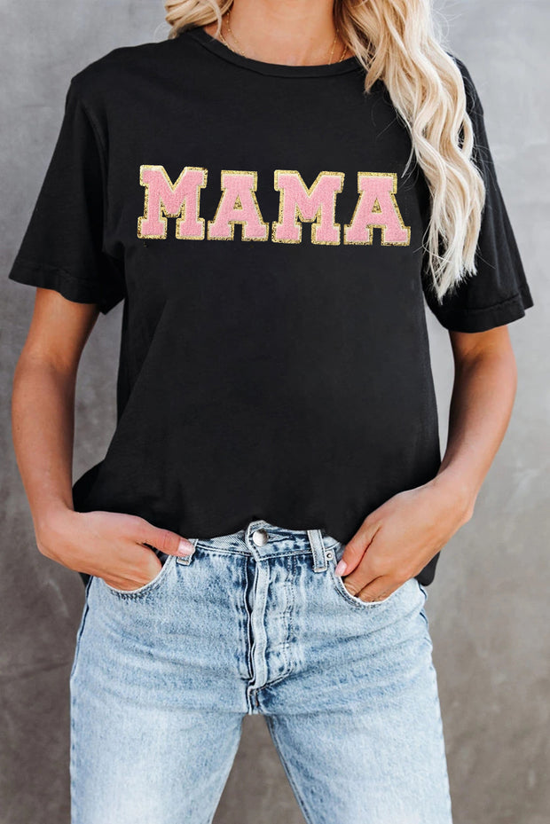 a woman wearing a black shirt with the word mama printed on it