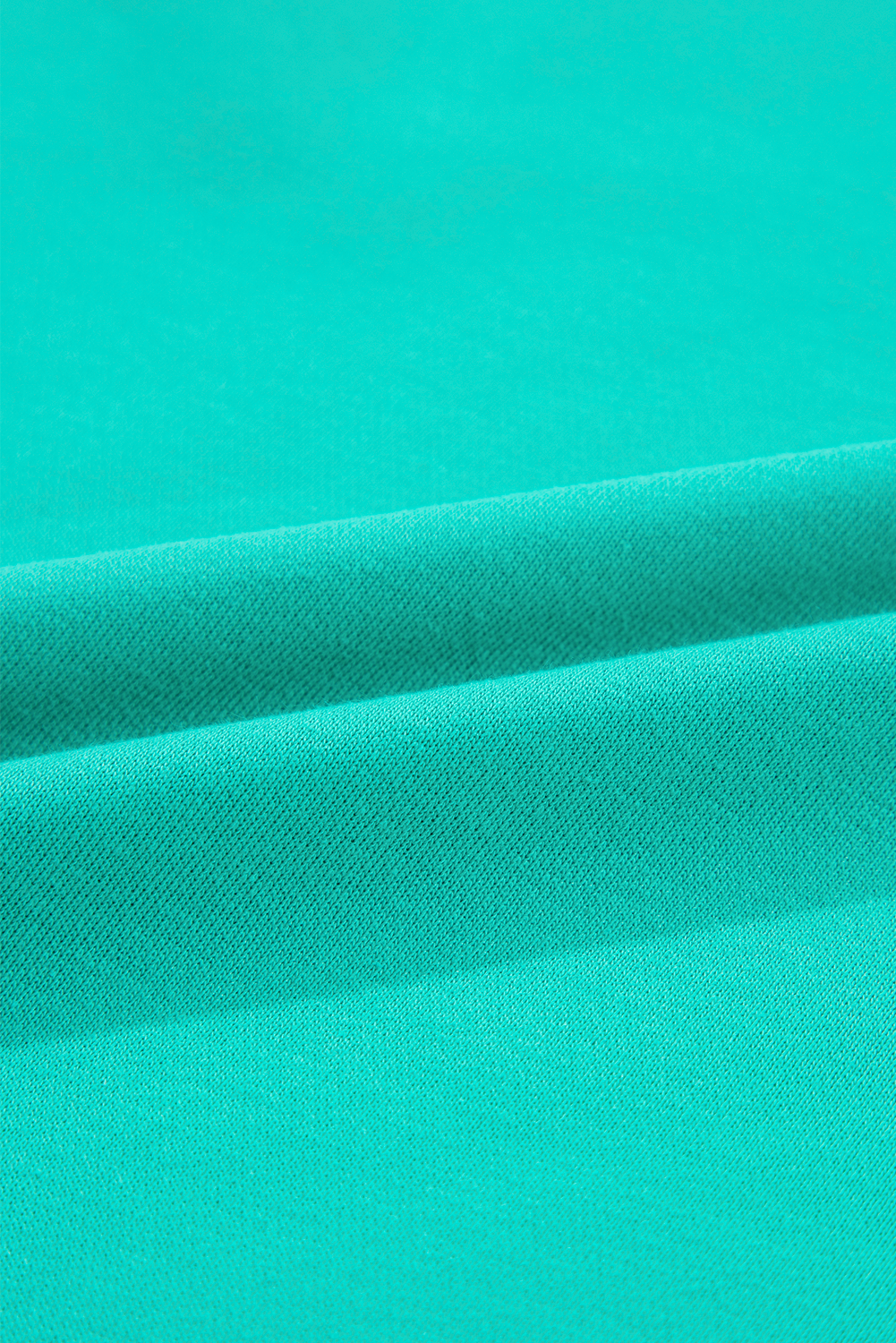 Fabric texture close-up of Aruba Blue Plaid Vintage Paisley Patchwork Long Sleeve Raglan Top. Shop this soft top at Faith & Co. Boutique.