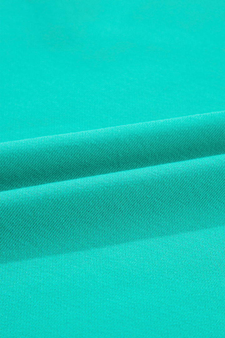 Fabric texture close-up of Aruba Blue Plaid Vintage Paisley Patchwork Long Sleeve Raglan Top. Shop this soft top at Faith & Co. Boutique.