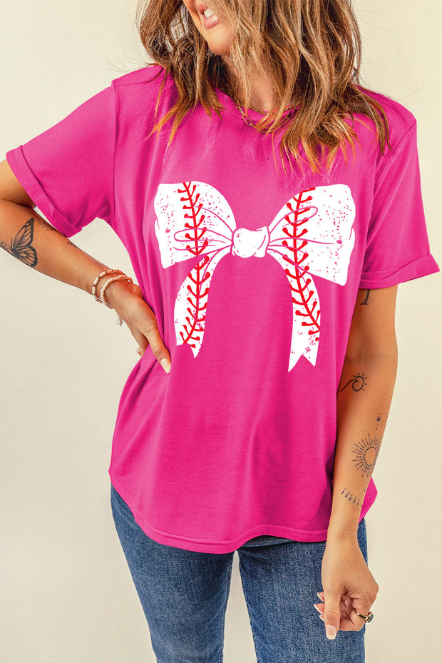 a woman wearing a pink shirt with a baseball bow