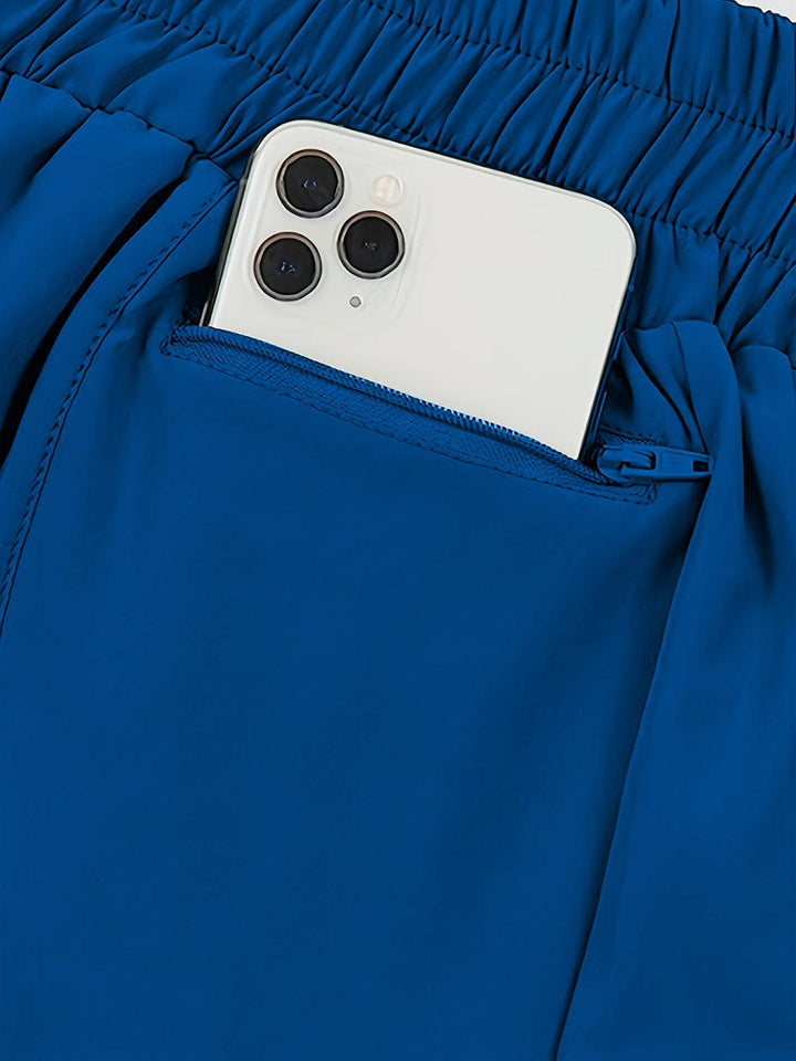 a cell phone sticking out of the pocket of a pair of blue pants