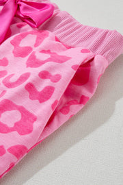 a pink leopard print dress with a pink bow