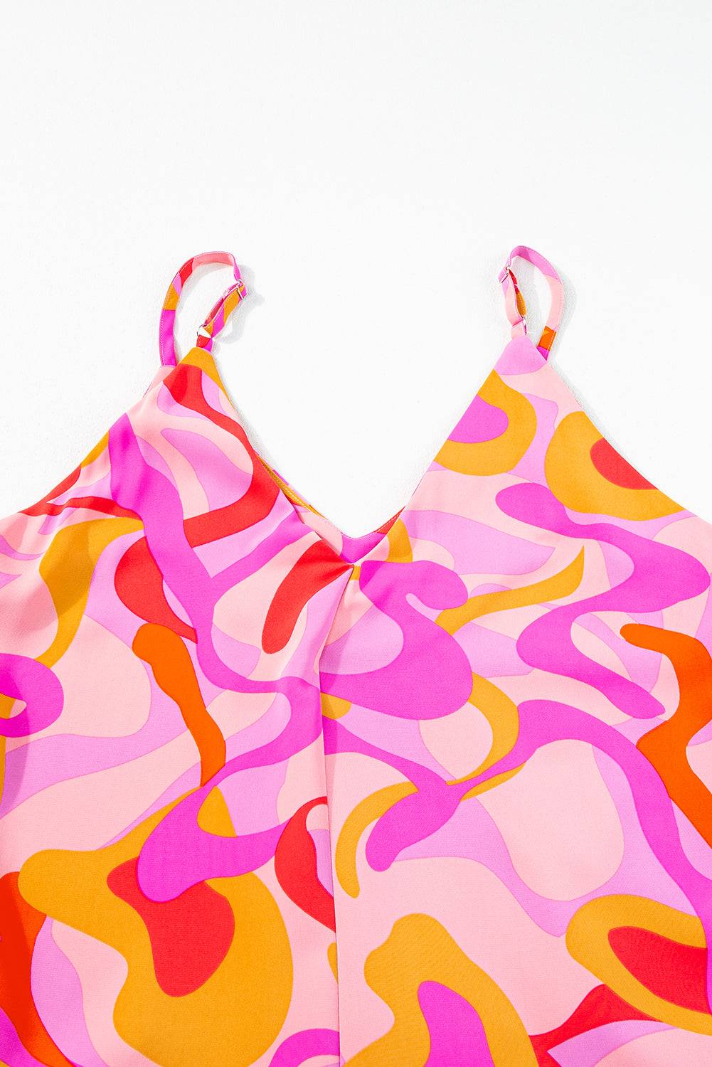 a woman's pink and yellow dress on a white background