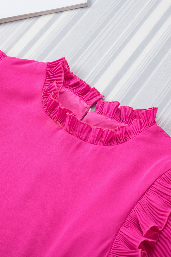 a close up of a pink dress on a table