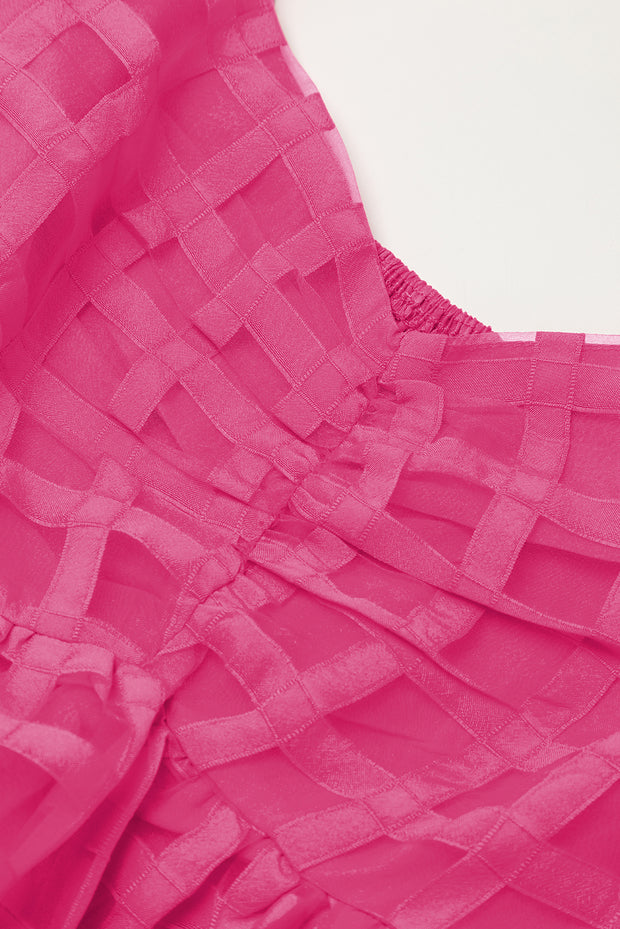 a close up of a pink dress on a white surface