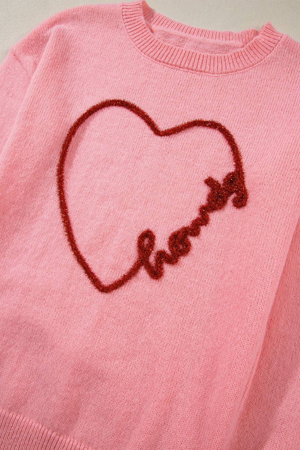 a pink sweater with a heart drawn on it