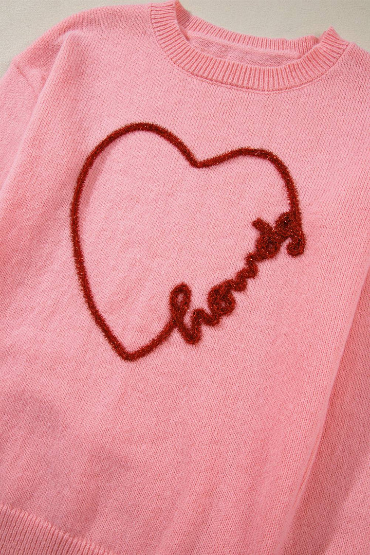 a pink sweater with a heart drawn on it