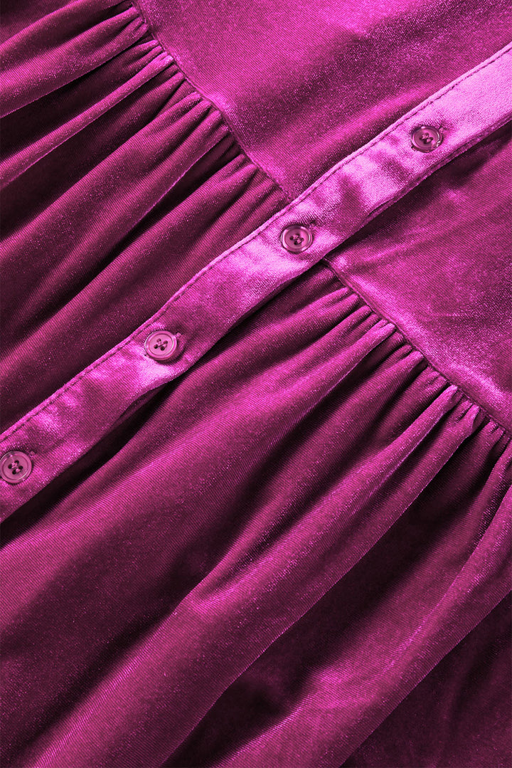 a close up of a purple dress with buttons