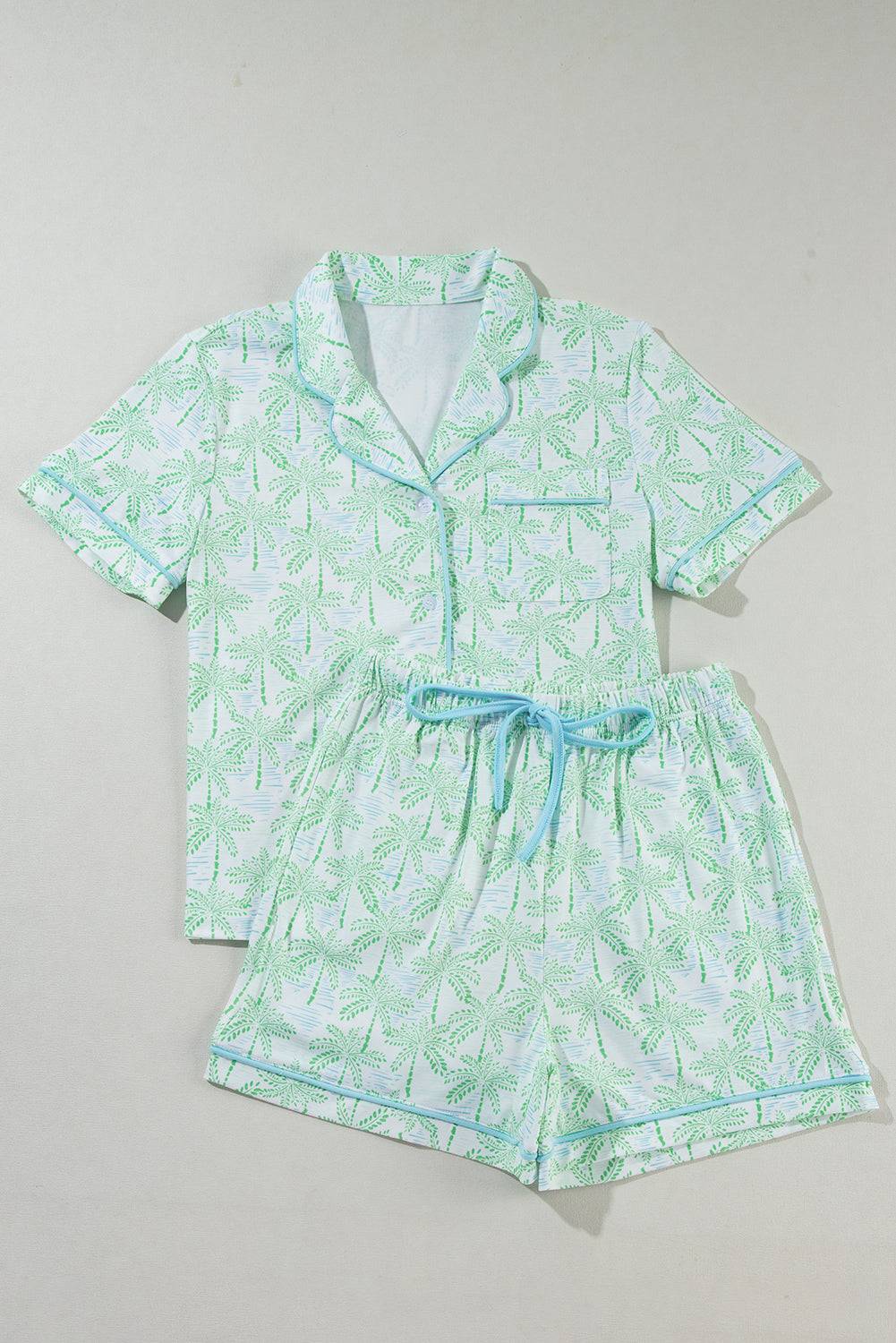 a boy's pajama set with a green leaf print