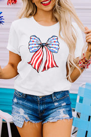 a woman wearing a white shirt with an american flag bow on it