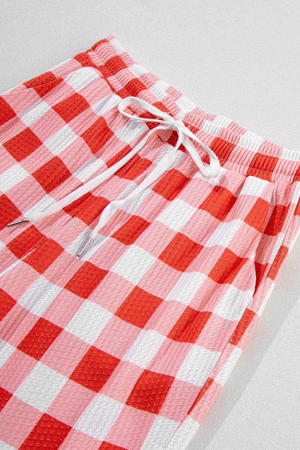 a close up of a red and white checkered shorts