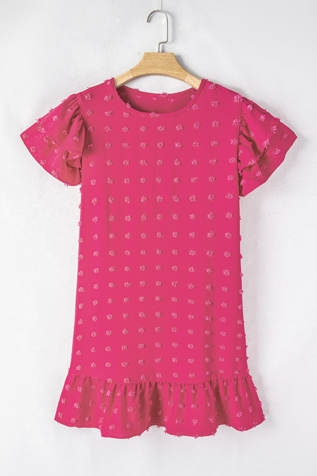 a pink top hanging on a wooden hanger