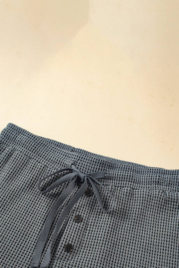 a close up of a person's pants with a tie