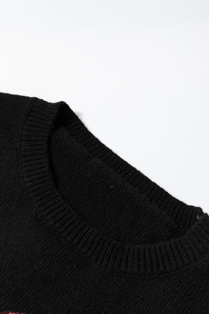 a close up of a black sweater on a white surface