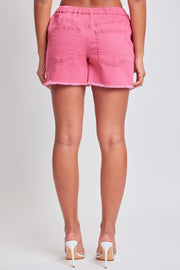 a woman wearing pink shorts and high heels